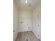 Laundry room with overhead hanging rod and wood laminate flooring at 1837 Water Birch Way, Castle Rock, CO 80108