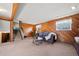 Spacious basement rec room with wood paneled walls and a fireplace at 12801 Monroe St, Thornton, CO 80241