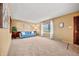 Spacious living room with a blue sofa and large windows at 12801 Monroe St, Thornton, CO 80241