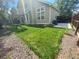 Grass backyard with gravel border and partial view of house at 4856 S Argonne St, Aurora, CO 80015