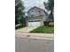 Two-story house with a white double garage door and green lawn at 4856 S Argonne St, Aurora, CO 80015