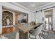 Elegant dining room with a rustic wood table and barn door at 244 Cheney Pl, Castle Rock, CO 80104