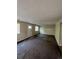 Large living room with carpet, neutral walls, and exterior access at 2721 S Salida Way, Aurora, CO 80013