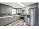 Modern kitchen with gray cabinets, stainless steel appliances, and quartz countertops at 1248 Meadow St, Longmont, CO 80501