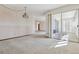Spacious living room with neutral carpeting and balcony access at 660 S Alton Way # 5C, Denver, CO 80247