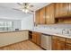 Kitchen boasts wood cabinets, stainless steel dishwasher, and access to living area at 660 S Alton Way # 5C, Denver, CO 80247