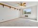 Spacious bedroom with ceiling fan and large window at 660 S Alton Way # 5C, Denver, CO 80247