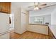 Kitchen area with wood cabinets, refrigerator, and access to other rooms at 660 S Alton Way # 5C, Denver, CO 80247