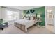 Main bedroom with an ensuite bathroom and green accent wall at 3305 Belleville Ridge Rd, Elizabeth, CO 80107