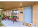 Brick front porch with wicker chairs and a welcome mat at 7131 Clay St, Westminster, CO 80030
