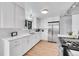 Updated kitchen featuring white cabinets and new appliances at 7131 Clay St, Westminster, CO 80030