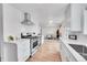 Modern white kitchen with stainless steel appliances and dining area view at 7131 Clay St, Westminster, CO 80030