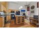 Open concept kitchen featuring island, wood cabinets, and black appliances at 1555 California St # 316, Denver, CO 80202
