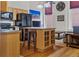 Open kitchen with island, wood cabinets, and black appliances at 1555 California St # 316, Denver, CO 80202