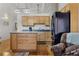 Kitchen boasts an island, wood cabinets, and a breakfast bar at 1555 California St # 316, Denver, CO 80202