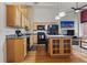 Modern kitchen with island, granite countertops, and stainless steel appliances at 1555 California St # 316, Denver, CO 80202