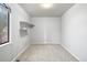 Simple bedroom with carpeted floors and a large window at 11622 E Cedar Ave, Aurora, CO 80012