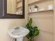 Small bathroom with pedestal sink and built-in shelving at 1657 Vine St, Denver, CO 80206