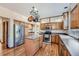 Kitchen with wood cabinets, stainless steel appliances, and an island at 13159 Bellaire Ct, Thornton, CO 80241