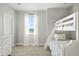 Bedroom featuring white bunk beds, neutral carpet, and bright, airy windows at 1823 Salers Way, Erie, CO 80516