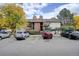 Building exterior with parking lot and autumn trees at 14602 E 2Nd Ave # 100C, Aurora, CO 80011