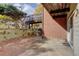Small patio area with brick wall and wooden deck above at 14602 E 2Nd Ave # 100C, Aurora, CO 80011