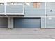 Attached garage with gray door and ample parking space at 11722 E Cedar Ave, Aurora, CO 80012