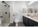 Contemporary bathroom with dual vanity and walk-in shower at 18633 Stroh Rd # 2-105, Parker, CO 80134