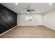 Light and airy living room with hardwood floors and accent wall at 5519 Troy St, Denver, CO 80239