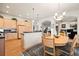 Bright kitchen features an island, light wood cabinets, and a view to the Gathering room at 5901 W Lehigh Ave # 9, Denver, CO 80235