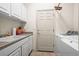 Laundry room with washer, dryer, and storage at 5901 W Lehigh Ave # 9, Denver, CO 80235