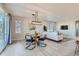 Bright dining area features a round table, four chairs, and a modern chandelier at 711 N Waterloo Ct, Aurora, CO 80018