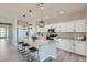 Modern kitchen with white cabinets, granite countertops, and island at 711 N Waterloo Ct, Aurora, CO 80018