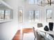 Formal dining room featuring large windows, hardwood floors, and a modern chandelier at 385 Baxter Farm Ln, Erie, CO 80516