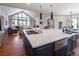 Modern kitchen with large island, stainless steel appliances, and hardwood floors at 385 Baxter Farm Ln, Erie, CO 80516