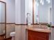 Powder room with red vanity and a full-length mirror at 385 Baxter Farm Ln, Erie, CO 80516