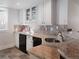 Basement wet bar with granite countertop and white cabinets at 385 Baxter Farm Ln, Erie, CO 80516