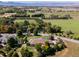 Aerial view of house and expansive property with mountain views at 385 Baxter Farm Ln, Erie, CO 80516