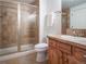 Basement bathroom with shower, toilet and wood vanity at 385 Baxter Farm Ln, Erie, CO 80516