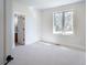 Bright bedroom with ensuite bathroom and a view of the backyard at 385 Baxter Farm Ln, Erie, CO 80516
