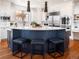 Modern kitchen with a large curved island and stainless steel appliances at 385 Baxter Farm Ln, Erie, CO 80516