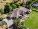 Aerial view of house, expansive lawn, and mature trees at 385 Baxter Farm Ln, Erie, CO 80516