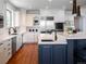 Modern kitchen with white cabinets, stainless steel appliances, and a large island at 385 Baxter Farm Ln, Erie, CO 80516