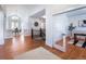 Elegant entryway with hardwood floors and view into dining and living areas at 385 Baxter Farm Ln, Erie, CO 80516