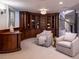 Basement sitting area with built-in curved shelving and fireplace at 385 Baxter Farm Ln, Erie, CO 80516