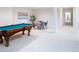 Basement recreation area with pool table and seating at 385 Baxter Farm Ln, Erie, CO 80516
