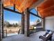 Covered porch with stone pillars and outdoor seating at 385 Baxter Farm Ln, Erie, CO 80516