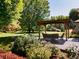 Landscaped patio with pergola and seating area at 385 Baxter Farm Ln, Erie, CO 80516