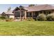 House exterior showcasing landscaping and large lawn at 385 Baxter Farm Ln, Erie, CO 80516