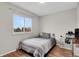 Bedroom with a full-size bed, window, and a small shelving unit at 2103 Coronado N. Pkwy # D, Denver, CO 80229